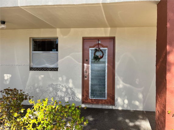 Front view of a house with a single front door and a window beside it.