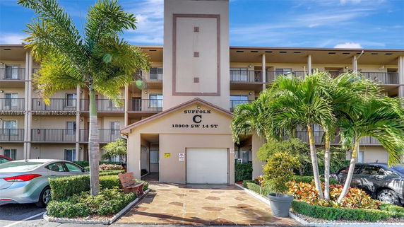 Front view of a multi-story residential building with balconies.