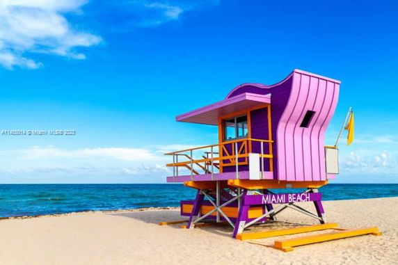 Front view of a colorful lifeguard tower on a beach.