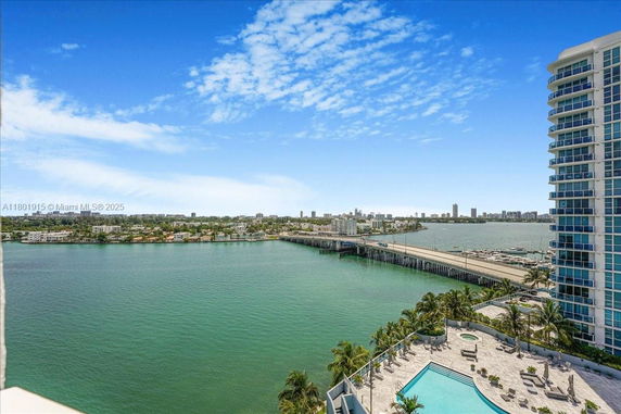Panoramic view from a high-rise building showing a body of water and cityscape in the background.