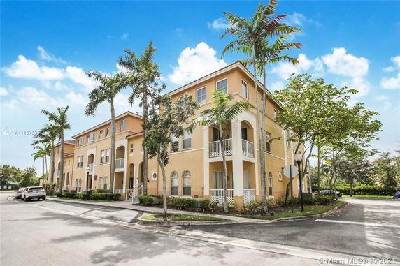 Front view of a multi-story residential building with balconies.
