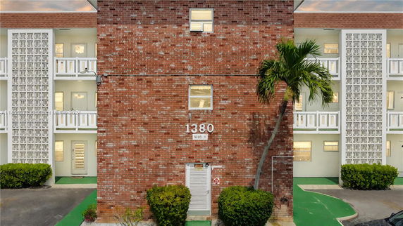 Front view of a brick multi-story building with numbered facade.