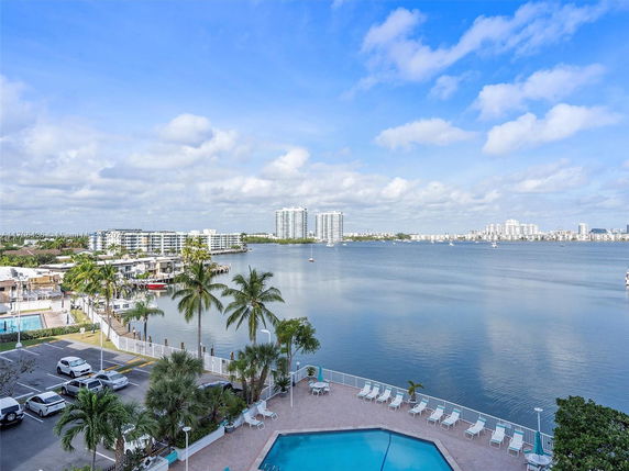 Panoramic view of waterfront area with buildings and a swimming pool.