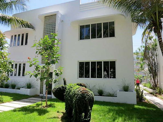 Front view of a modern two-story white building with large windows.