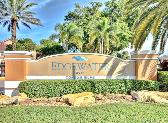Signage for Edgewater Condominiums with surrounding greenery.