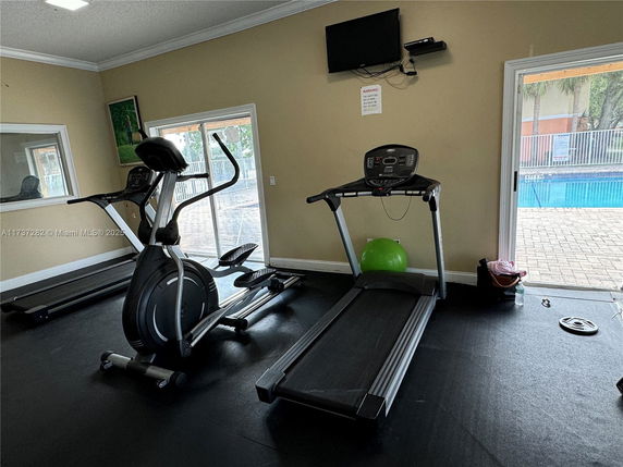 Indoor gym with exercise equipment including a treadmill and elliptical machine.