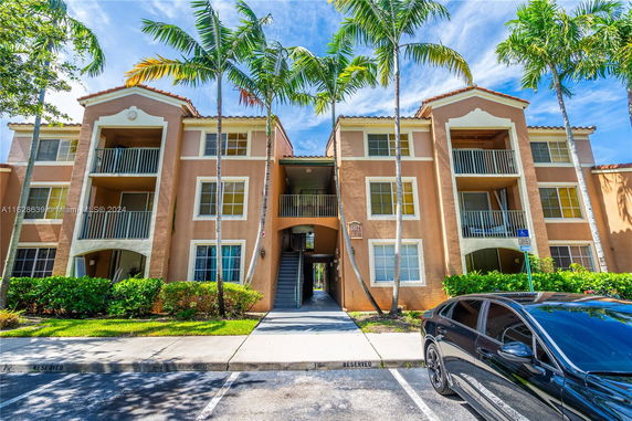 Front view of a three-story residential building with balconies.