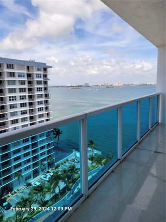 View from a high balcony overlooking the water and buildings.