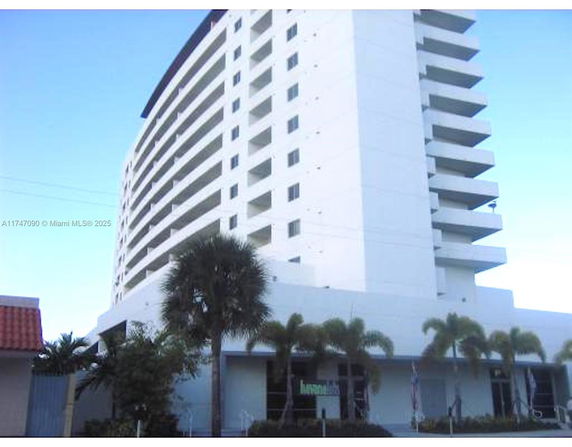 Front view of a multi-story building with balconies.