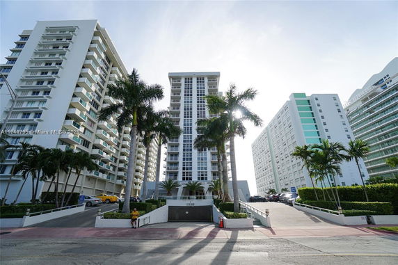 Front view of a multi-story residential building with balconies.