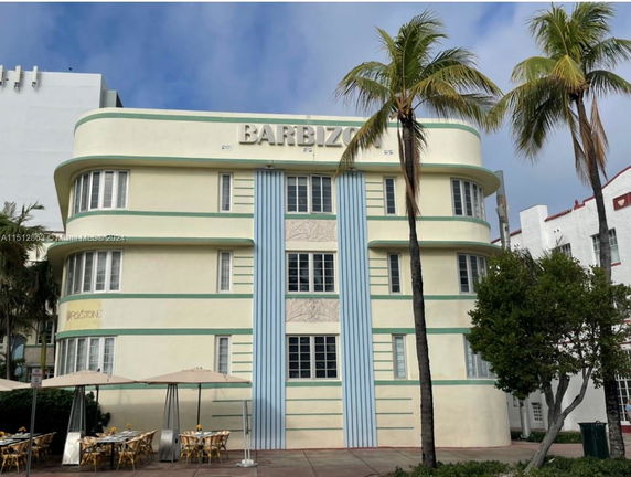 Front view of a multi-story Art Deco building with rounded corners and a flat roof.