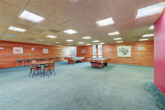 Recreation room with pool tables and seating area.