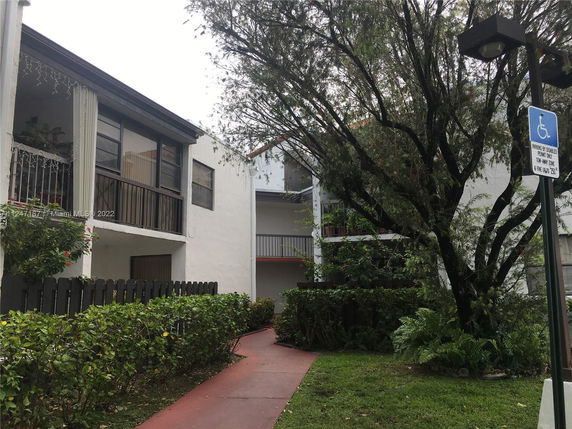Front view of a two-story residential building with balconies.
