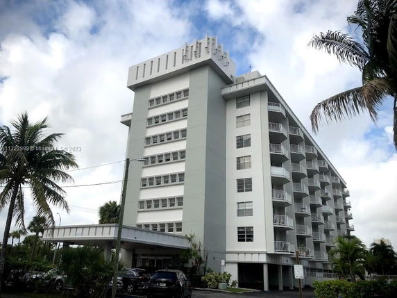 Front view of a multi-story apartment building with balconies.
