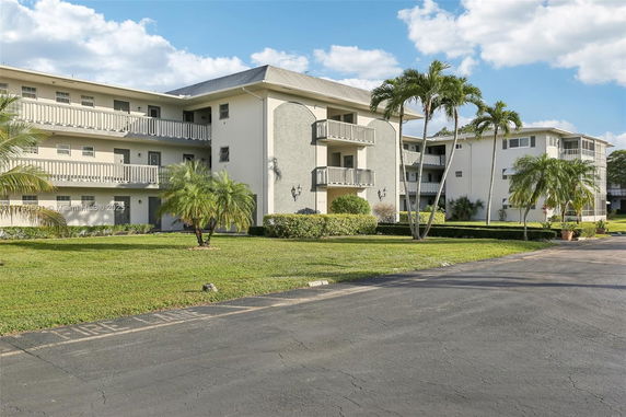Front view of a multi-story residential building with balconies.