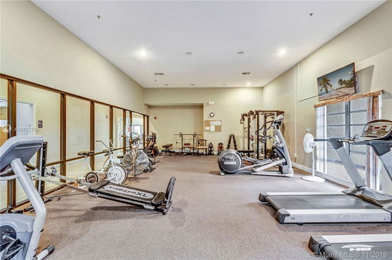 Indoor gym area with various exercise equipment including treadmills and bikes.
