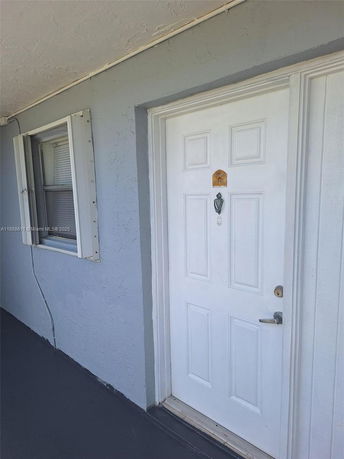 Front view of a building door with a window beside it.
