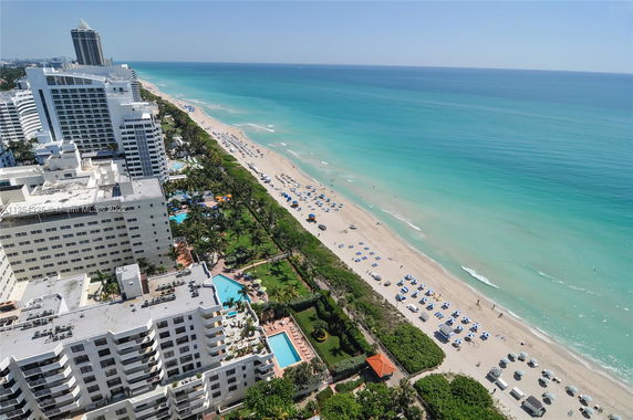 Wide-angle view of beachfront buildings and coastline.