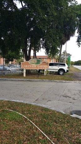 Outdoor view with a parking area and a sign reading 'Lakeview Garden'.