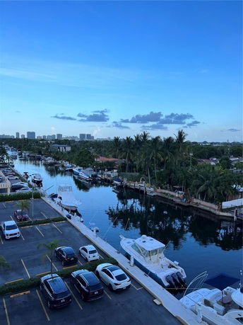 Wide angle view of a marina with boats and surrounding landscape.