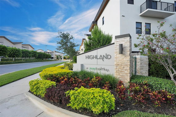Front view of a modern residential complex with a prominent entrance sign.