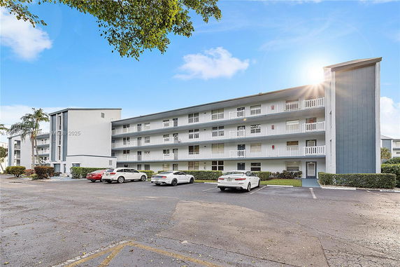 Front view of a multi-story residential building with balconies.
