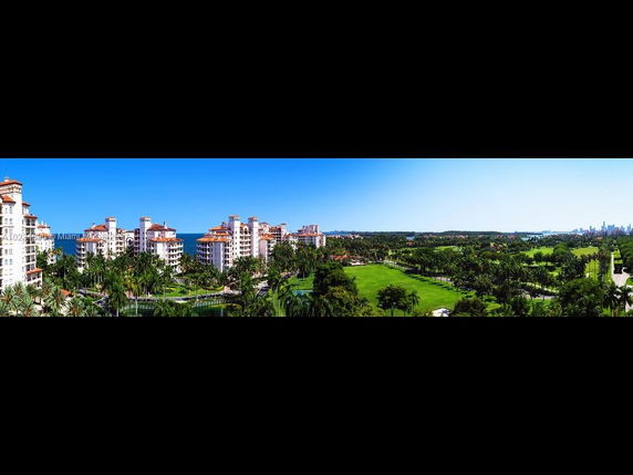 Panoramic view of a residential complex with multiple multi-story buildings and surrounding greenery.