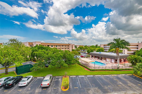 Panoramic view of a residential area with multiple buildings and a swimming pool.