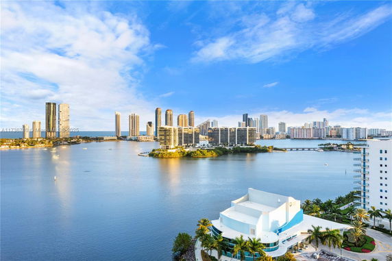 Panoramic view of downtown with water and high-rise buildings.