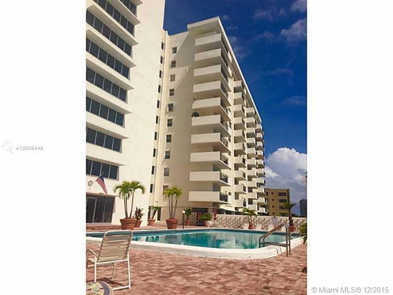 Front view of a multi-story apartment building with balconies.