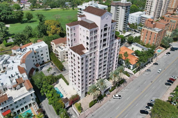 Front view of a multi-story residential building with numerous balconies.