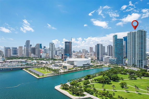 Cityscape with high-rise buildings and a waterfront view.