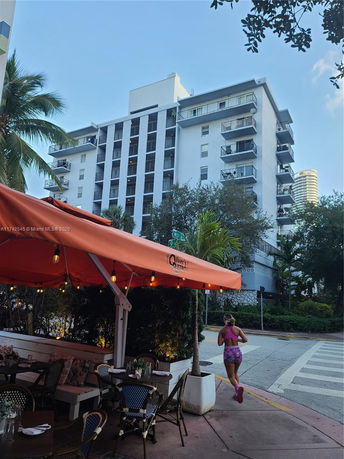 Front view of a multi-story residential building with balconies.