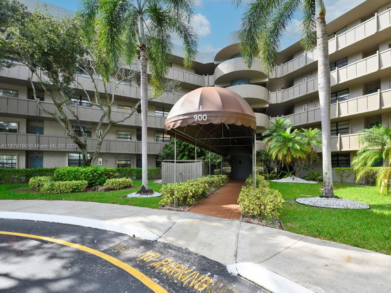 Front view of a multi-story residential building with a covered entrance.