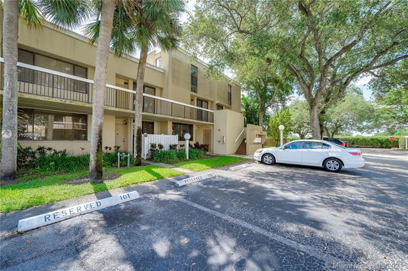 Front view of a multi-story residential building with balconies.
