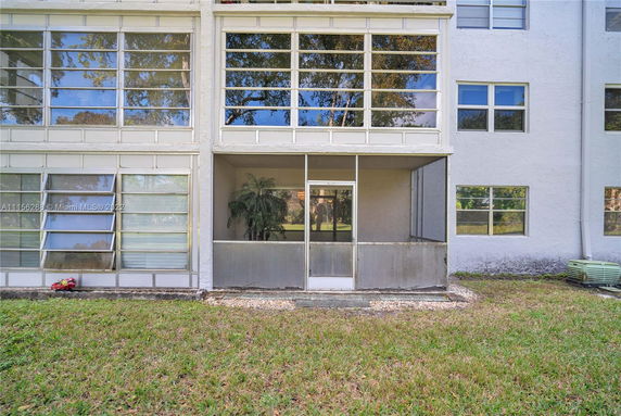 Exterior view of a multi-story building with screened-in porch areas.