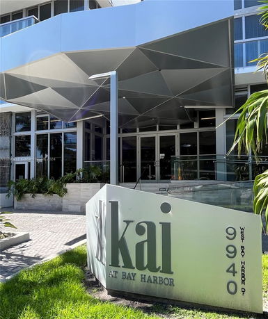 Front view of a building with modern geometric canopy design.