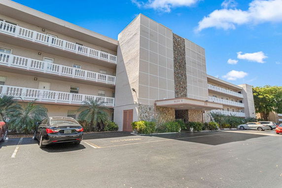 Front view of a multi-story residential building with balconies.