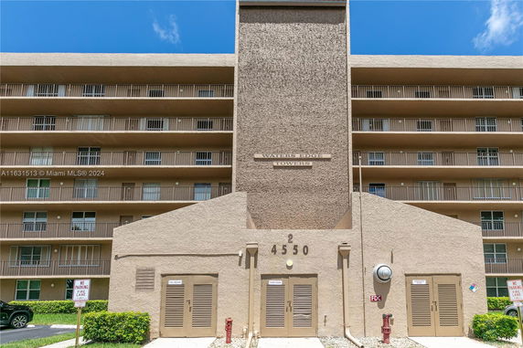 Front view of a multi-story building with balconies.