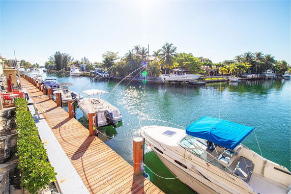 Panoramic view of a dock with boats moored along a canal.