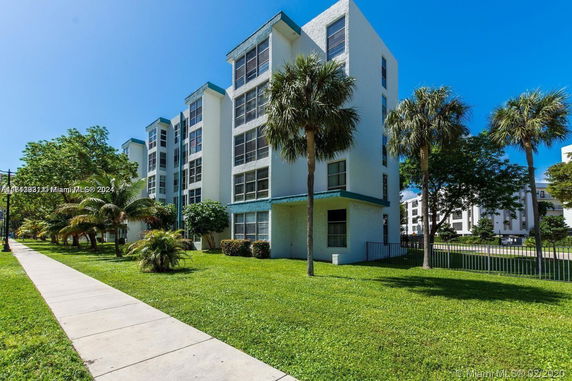 Front view of a mid-rise residential building with multiple windows.