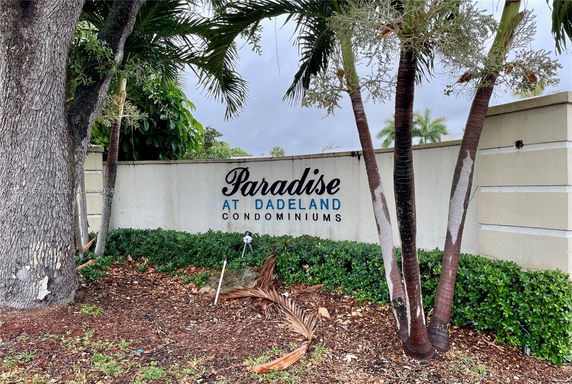 Front view of entrance sign for Paradise at Dadeland Condominiums.