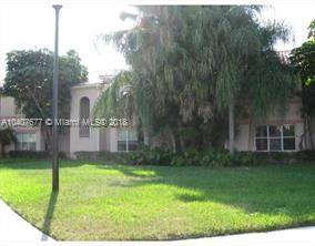Front view of a single-story house with arched windows.