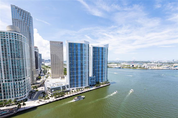 View of high-rise buildings alongside a waterfront.