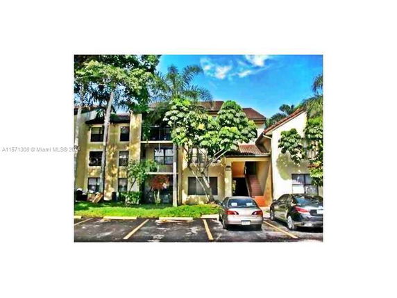 Front view of a multi-story apartment building with a staircase entrance.