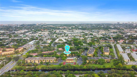 Aerial panoramic view of a suburban area with residential buildings and roads.