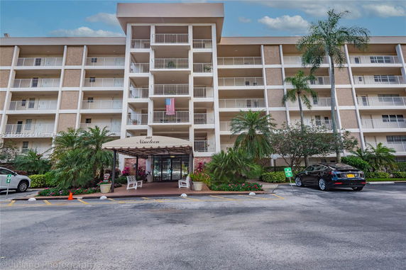 Front view of a multi-story residential building with balconies.