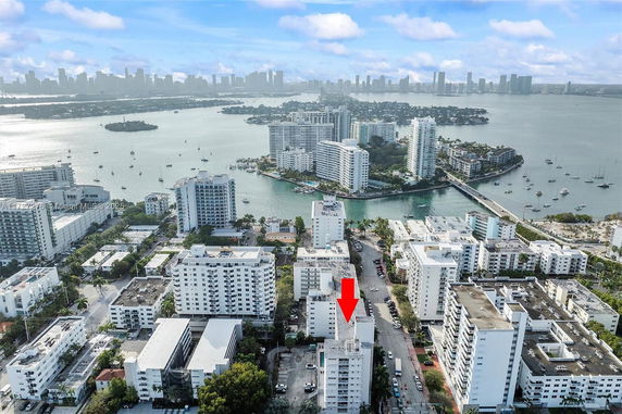 Aerial panoramic view of a city with multiple high-rise buildings near a body of water.