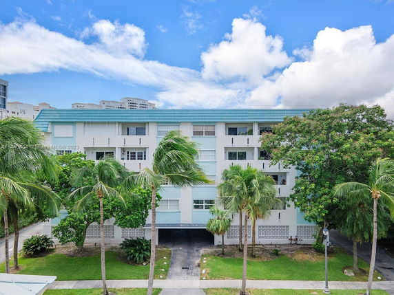 Front view of a mid-rise residential building with a blue roof.
