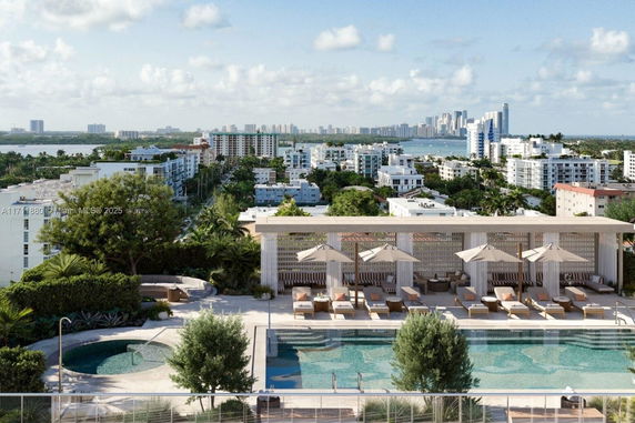 Panoramic view of a cityscape with high-rise buildings and a swimming pool in the foreground.